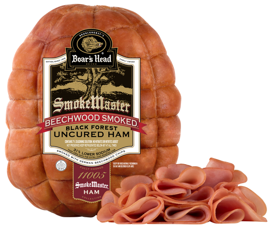 A large spiral-cut smoked ham wheel with a prominent Boar's Head SmokeMaster label, shown on a white background with several slices cut from the front revealing the pink cured meat inside.