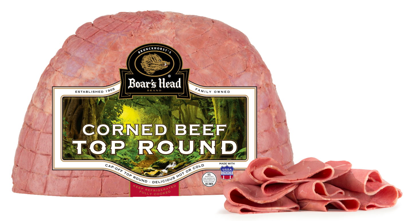 Boar's Head Corned Beef Top Round in its branded vacuum packaging, with several slices cut from the front resting on a white background.