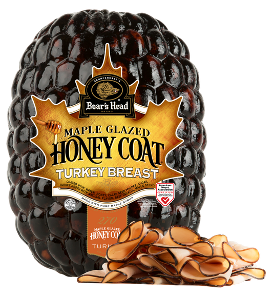 Boar's Head Maple Glazed Honey Coat Turkey Breast in a clear plastic bag with a large gold and black label, shown on a white background with sliced turkey pieces in front.