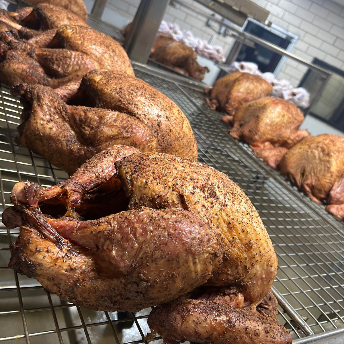 Smoked turkeys on metal racks